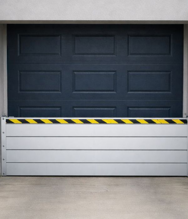 Flood barrier system for garage doors and large building openings